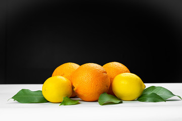 oranges and lemons on wooden table