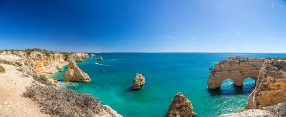 Fotobehang View on typical cliffy beach at Algarve coastline in Portugal in summer © Aquarius