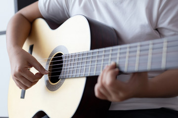 Woman hands playing acoustic classic guitar the musician of jazz and easy listening style select focus shallow depth of field