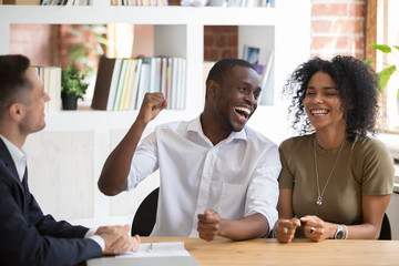 Excited black couple feel euphoric closing deal with realtor