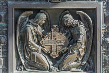 Angels with the Cross . Element of decorative gates,