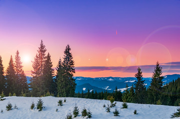 Magic pink sunset high in the winter mountains.
