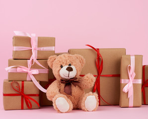 brown cute teddy bear and gifts wrapped in brown eco kraft paper and tied with a ribbon