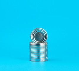 open hard iron can for food preservation on a blue background,