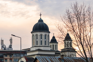 Orthodox cathedral against a sunset sky.  Targoviste, Romania, 2020.