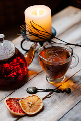 Composition with natural healthy organic herbal rooibos tea in glass teapot and cup. Wooden...