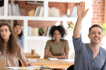 Motivated male student ask hand asking question at lesson