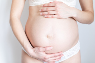 Fototapeta na wymiar young pregnant woman caressing her tummy