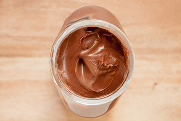 Chocolate spreading cream in a glass jar