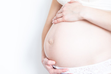 young pregnant woman caressing her tummy