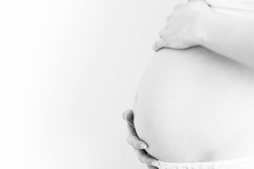 young pregnant woman caressing her tummy