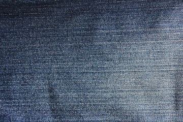 Dark blue denim jeans background. Washed out old jean fabric pattern, casual denim cloth texture, empty clothing concept wallpaper 