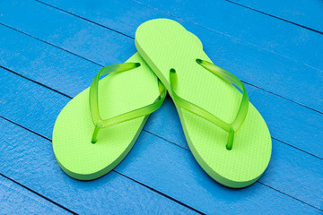 flip flops on wooden blue table
