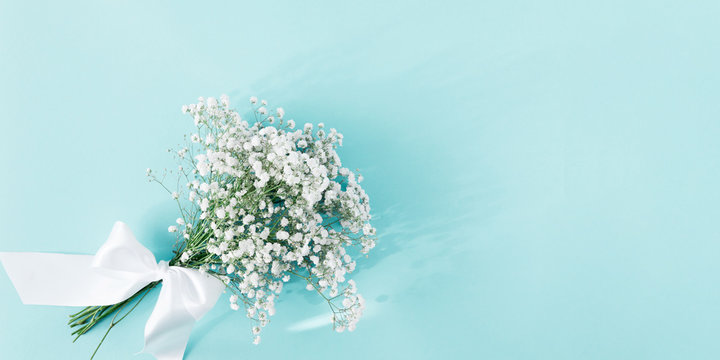 Flowers composition romantic. Bouquet white flowers gypsophila on pastel blue background. Valentines Day, Easter, Birthday, Happy Women's Day, Mother's day. Flat lay, top view, copy space