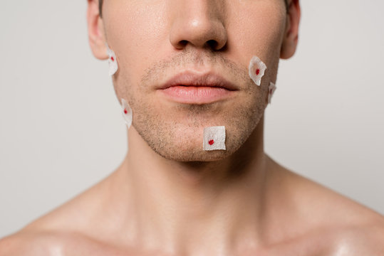 Cropped View Of Naked Man With Bloody Wounds After Shaving On Face Isolated On Grey