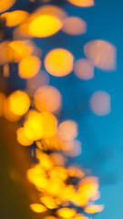 A scattering of bokeh yellow lights on a background of the night sky