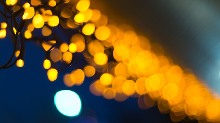 A scattering of bokeh yellow lights on a background of the night sky