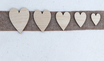 Wooden hearts on a natural fabric background