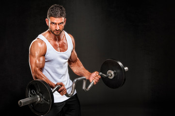 Fototapeta na wymiar Muscular Men, Bodybuilder Lifting Weights. Studio Shot