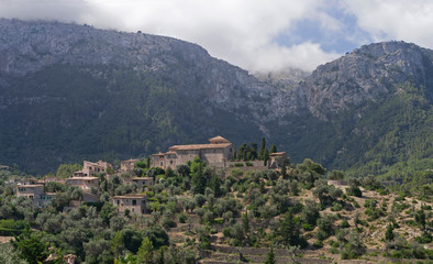 Fototapeta na wymiar Deia in Mallorca with misty mountains