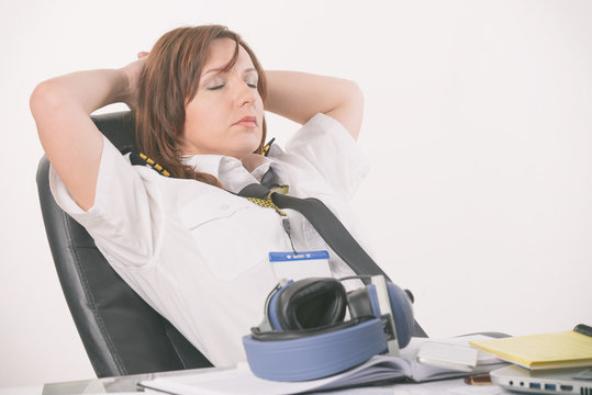 Woman airline pilot sleeping in the office