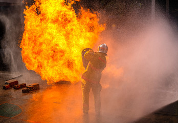 The Firefighters demonstrating fire fighting.