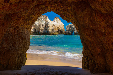 Natural caves in the impressive cliffs of Algarve coast in Portugal in summer