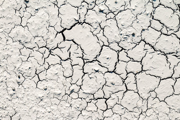 The structure of the earth's surface cracks, soil on a white background, desert cracks, arid surfaces in the dry ground, with many fissures and scratches