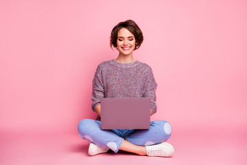 Portrait of her she nice attractive lovely charming pretty cute cheerful cheery brown-haired girl sitting in lotus pose using laptop typing e-mail isolated over pink pastel color background - obrazy, fototapety, plakaty