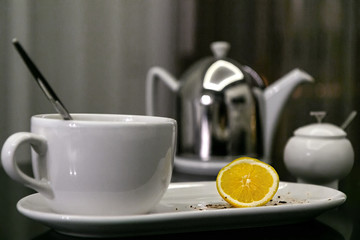 dirty dishes and the rest of the lemon after tea is on the kitchen table