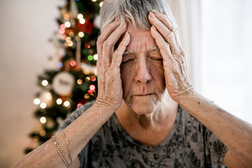 A Close-up of sad senior woman's face on the christmas day