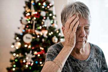 A Close-up of sad senior woman's face on the christmas day