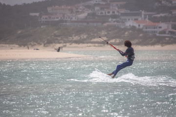 View of a professionals sports practicing extreme sports Kite-boarding at the Obidos lagoon, Foz do Arelho, Portugal
