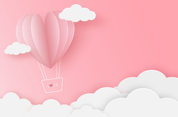 Paper heart balloon flying on the pink sky