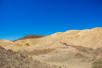 Fototapeta na wymiar sand stone desert rocky hills landscape wilderness scenic view environment vivid blue sky background space