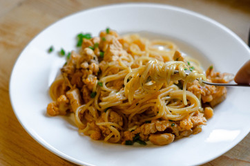 homemade spaghetti with meat and cauliflower on fork close up