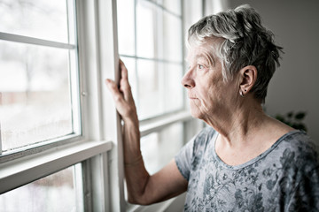 A sad lonely 70 years old senior in is apartment - obrazy, fototapety, plakaty