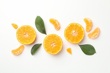 Mandarins and leaves on white background, top view