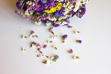 a bouquet of flowers lies on a white background. holiday concept, such as Valentine's Day, women's day, mother's day, birthday. flat lay. the concept of love and feelings. space for text. 