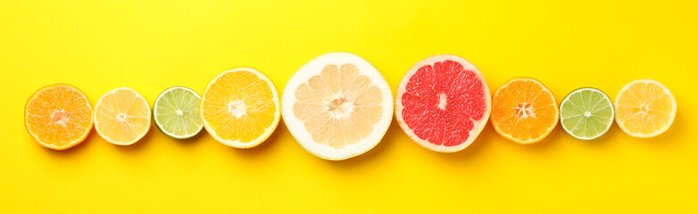 Naklejka na ściany i meble Flat lay with citrus fruits on yellow background, space for text