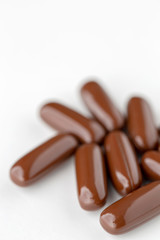 Pills tablets vitamins drugs brown close up macro shot