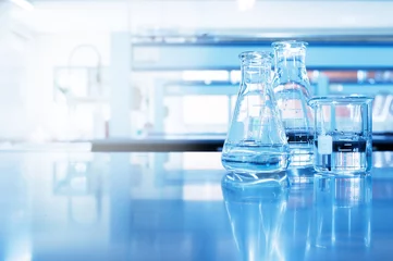 Foto op Plexiglas water in beaker and flask glass in chemistry blue science laboratory background © bidala