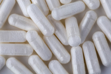 Pills tablets vitamins capsules drugs white close up macro shot