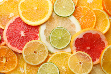 Fototapeta na wymiar Fresh citrus fruits slices texture background, close up