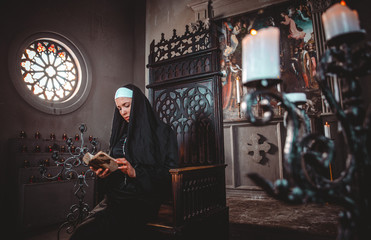 Nun praying in a monastery