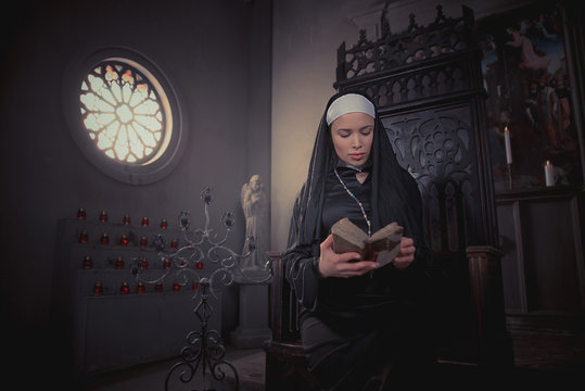 Nun praying in the convent