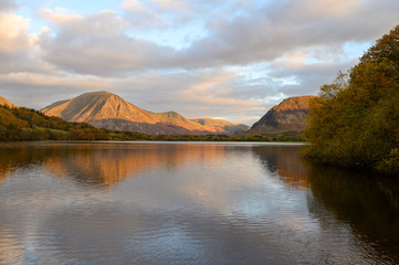 Sunset reaches the top of Grasmoor Fell looking across Loweswater in The Lake District,Cumbria,UK. - 315670871