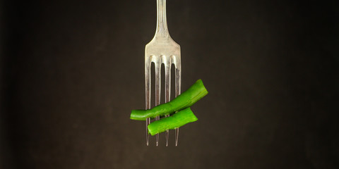 asparagus beans, green pod on a fork (ready to eat vegetables) menu concept. food background. top...