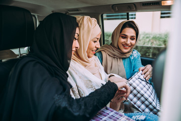 Three women friends going out in Dubai. Girls wearing the united arab emirates traditional abaya