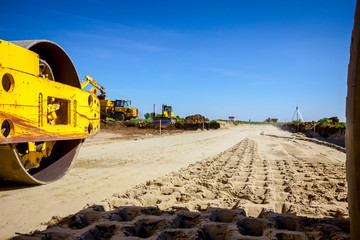 Trace of huge road roller with spikes to compact soil at construction site